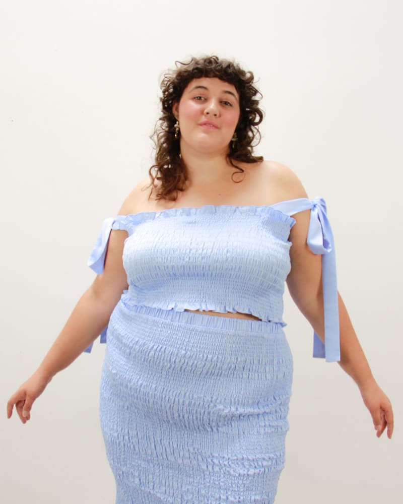Front of a model wearing a size L Cinch Me Smocked Skirt in SKY by Lovefool. | dia_product_style_image_id:265645